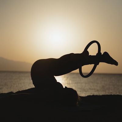 Person doing a side stretch in soft light.