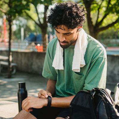 Water bottle and towel on a bench nearby.